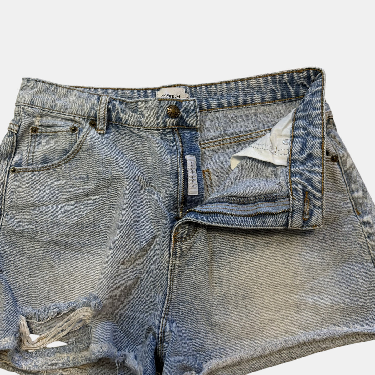 Ghanda High Waisted Light Wash Distressed Denim Shorts.